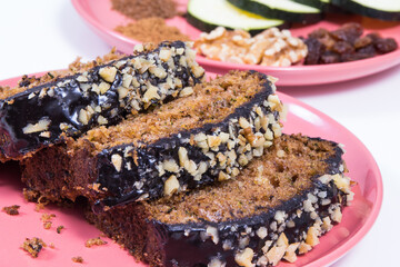 Pastry made of zucchini with nuts and raisin. Delicious dessert. White background