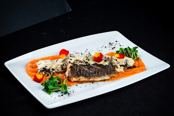 Fried white fish with mushrooms, sauce, carrot puree and microgreens, fresh lunch.