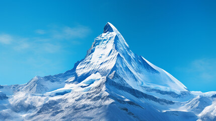 a snow-capped mountain peak with a bright blue sky in the background
