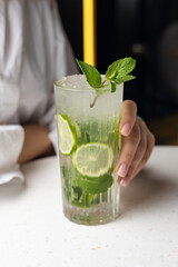 Alcoholic mojito cocktail with lime and mint