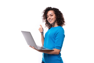 young successful leader woman showing like gesture and holding laptop in her hands