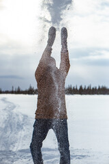 Cheerful man having fun in snowy tundra during holidays.