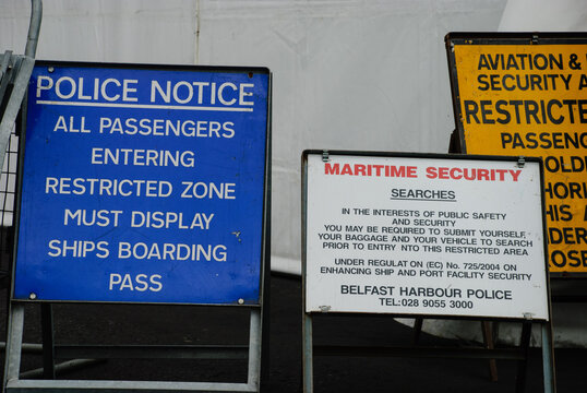 Security notices at the entrance to a controlled port entrance at Belfast warning that it is a restricted area, and they may be subject to searches.