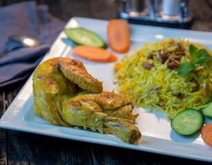 fried food on white plate and vegetables on wooden table ready to eat