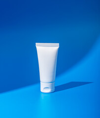 Cream tube mockup, small cosmetic package, pack mock-up on blue background