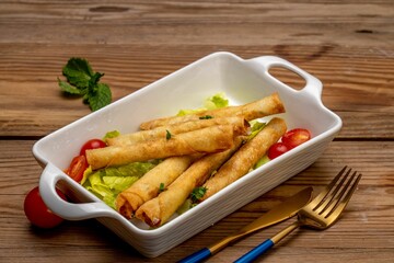 two tasty looking vegetable spring rolls in a white dish