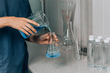 Women's hands in the laboratory examines the quality of water