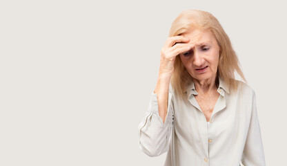 Tired faint senior adult old woman suffering from strong chronic headache migraine or memory loss...