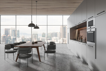 Grey home kitchen interior with eating table, cooking cabinet and window