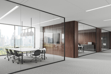 Fototapeta premium Stylish glass office room interior with table and seat, tv screen and window