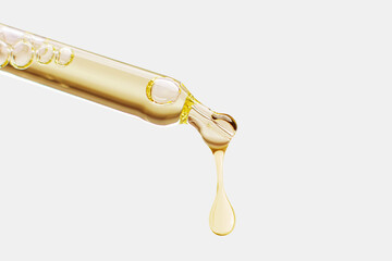 Cosmetic pipette with a falling drop of gold color on a light background.