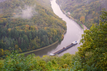 View from the treetop path to the Saar loop with rising clouds of fog on an autumn day