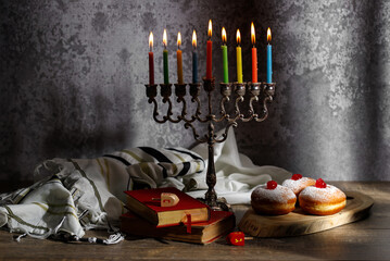 Jewish religious holiday Hanukkah with holiday Hanukkah (traditional candelabra), doughnut and...