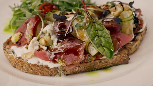 Close-up of bruschetta with jamon and cream cheese cooked in the professional kitchen of an Italian restaurant 