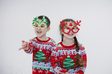 Preschool boy, girl in Christmas sweaters