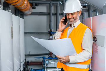 Architecture, phone and happy man with blueprint. Engineer with cellphone, talking with client and smile.