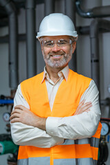 Portrait of a Professional Engineer Worker Wearing Uniform, Glasses and Hard Hat in a Steel Petrol Factory.