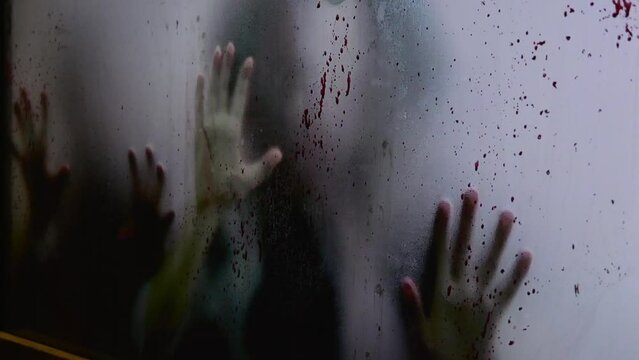 Blurred hands claw at blooded window, sign of deadly pandemic. Close-up of victims trapped by deadly pandemic, seeking escaped. Concept of prevention dispersion of deadly pandemic to save humanity.