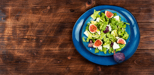 Fototapeta na wymiar Salad with juicy figs, herbs and cheese.
