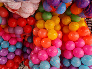 multicolored plastic balls in packaging in children's toy shop.
