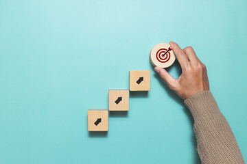 Hand hold wooden cube with target icon for a successful. Goal development and success. Concept of...