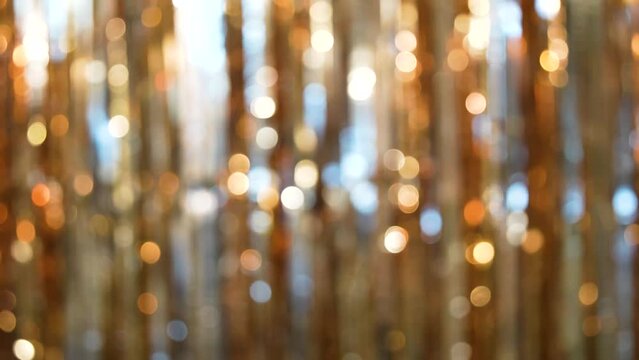 Blurred bokeh festive background made with foil fringe curtain