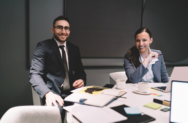 Cheerful colleagues working together in office