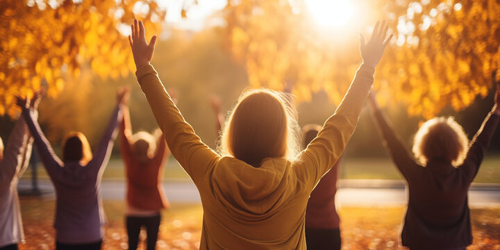 Group of young women doing yoga in the autumn park. Healthy lifestyle concept.