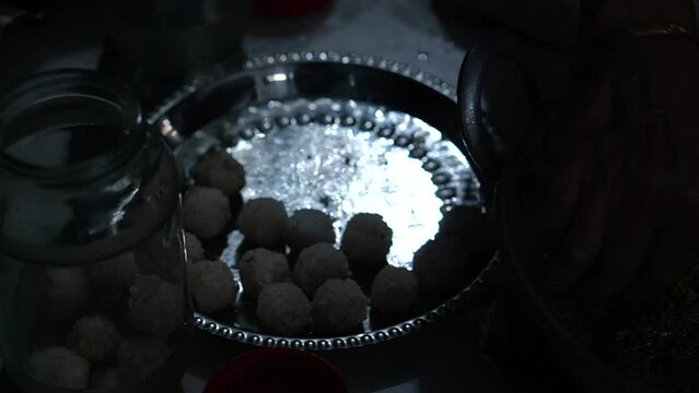 video clip of making home made coconut sweet delicacy in a kitchen in India on the auspicious occasion of Durga puja 