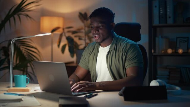 Happy guy celebrating success while looking on laptop screen