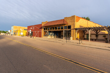 A strip of old bricks and wooden buildings along a city street, Quitaque, Texas - obrazy, fototapety, plakaty