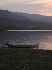 Boat in the lake at sunset. Rowing boat floating over the Limboto Lake waters. Gorontalo, Indonesia
