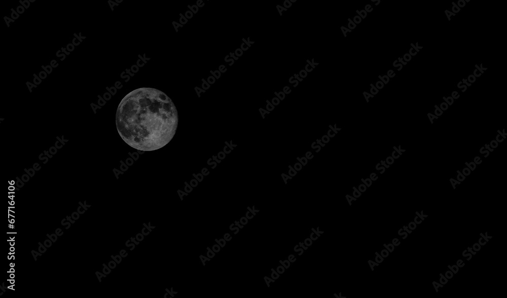 Wall mural full moon in the immense darkness of space
