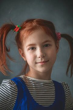 A funny cute portrait of a little girl presenting Pippi Longstocking