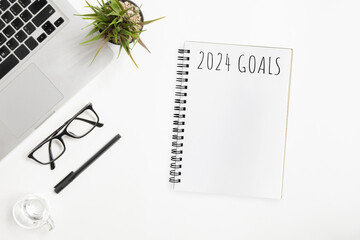 Notebook with 2024 goals text on it to apply new year resolutions and plan.