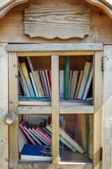 Obraz na płótnie Canvas Outdoor free book sharing mini house in close up, full frame photo