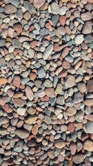 Colorful stones vertical background. Multi color beach stones small stones wallpaper