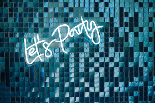 Photo zone decor with balloons of silver and blue collars , neons text birthday party let's party