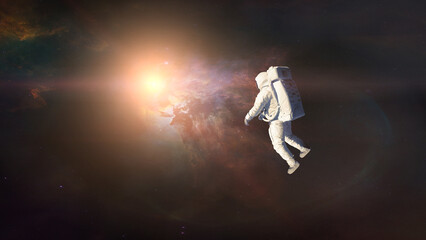 Cosmonaut floating in deep space on nebula background. Elements of this image furnished by NASA.