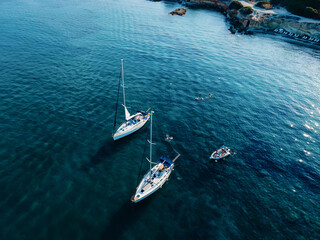 Aerial view of luxury yachts, sailing yachts, clear blue water. Travel. Cruise vacation. Yachting.