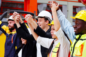 Engineers and employees wearing safety helmets are happy. Smiling, happy working in the factory.