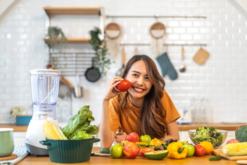 Portrait of beauty health asian woman having fun hold tomato cooking, vegan food healthy eat, fresh vegetable, Lycopene, vitamins, skincare, vegetarian in kitchen.Diet.Fitness, healthy food