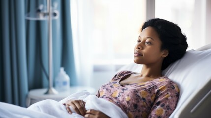 a pregnant woman in a hospital bed - obrazy, fototapety, plakaty