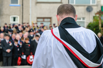 Remembrance Sunday commemoration.  Presbyterian minister leads audience in prayer