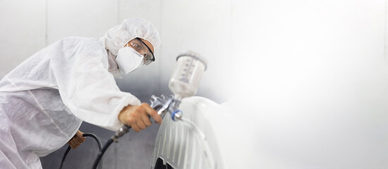 Auto mechanic car hispanic man worker working painting in car paint chamber. Body paint...