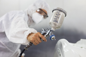 close up paint spray gun. paint garage. car in paint room at garage. Auto mechanic car hispanic man worker working painting in car paint chamber. Body paint garage - obrazy, fototapety, plakaty