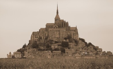 Panoramic view of Mont Saint Michel abbey in Northern France with antiqued sepia effect