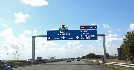 large road sign with French locations to go to the city of Paris or other places in France