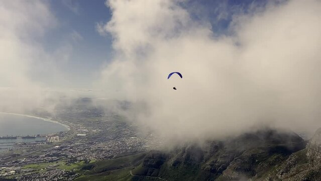 Paraglider flying over city of Cape Town. Table Mountain. Tourism in Africa concept.