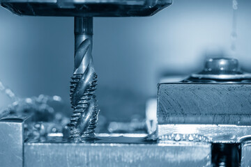 Close up scene the machine tapping process the metal plate by CNC milling machine.
